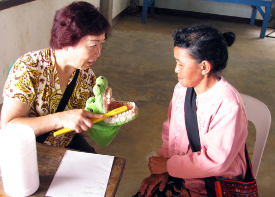 Photo: Teaching oral hygiene to a patient of the Akar minority ethnic group of the area.
